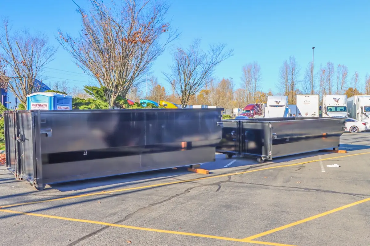 Professional dumpster rental service with roll-off container on residential driveway in West Athens